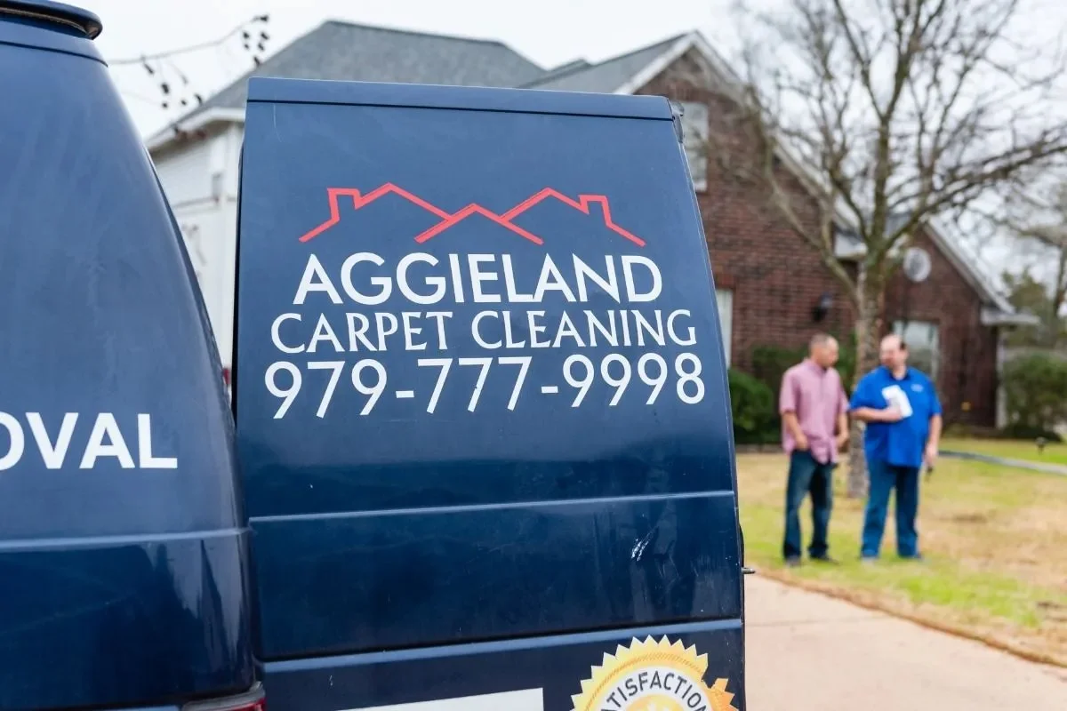 Aggieland Carpet Cleaning commercial service van parked outside a residential home in Bryan TX